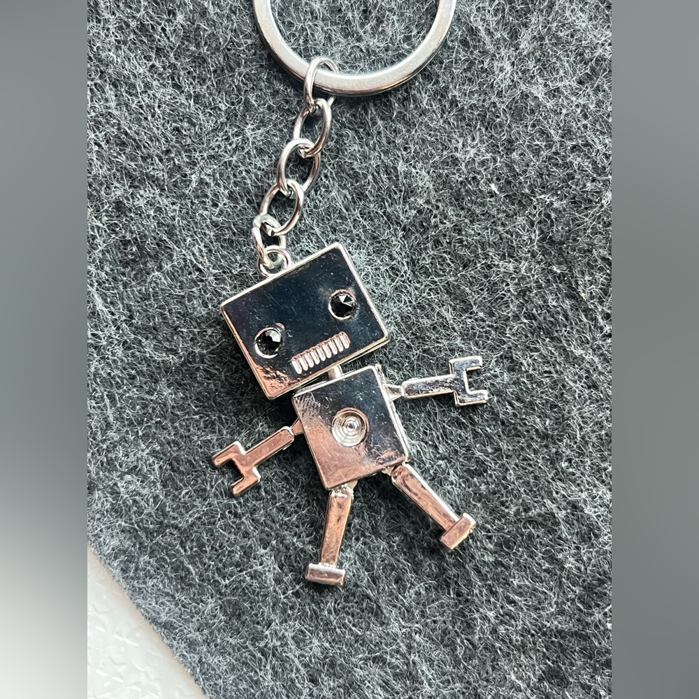 Silver toned robot keychain dangly legs and arms